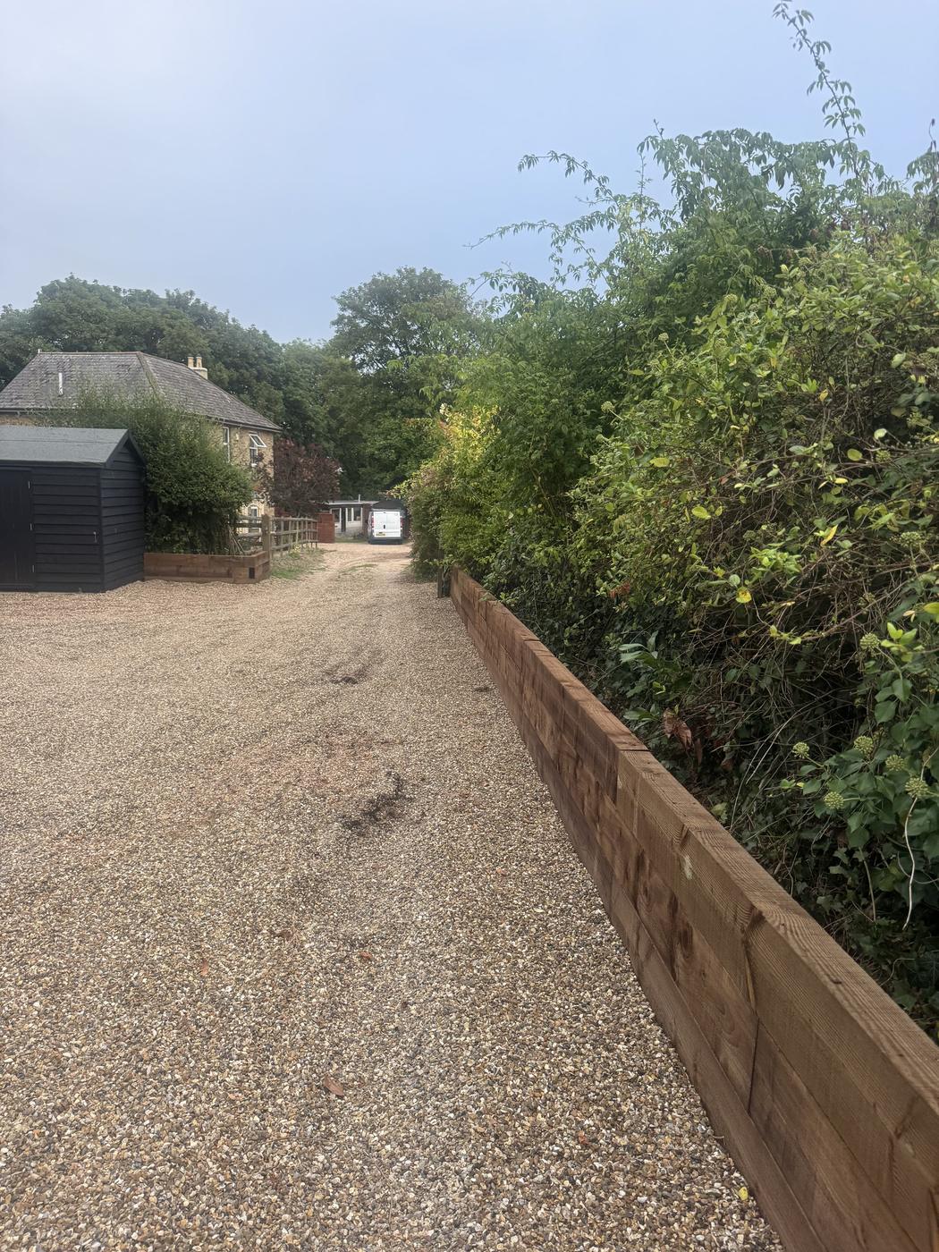 Gravel driveway with a timber sleeper retaining wall